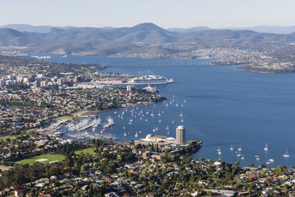 An aerial view over Hobart suburb of Sandy Bay and the port of Hobart with the Tasman Bridge in the background